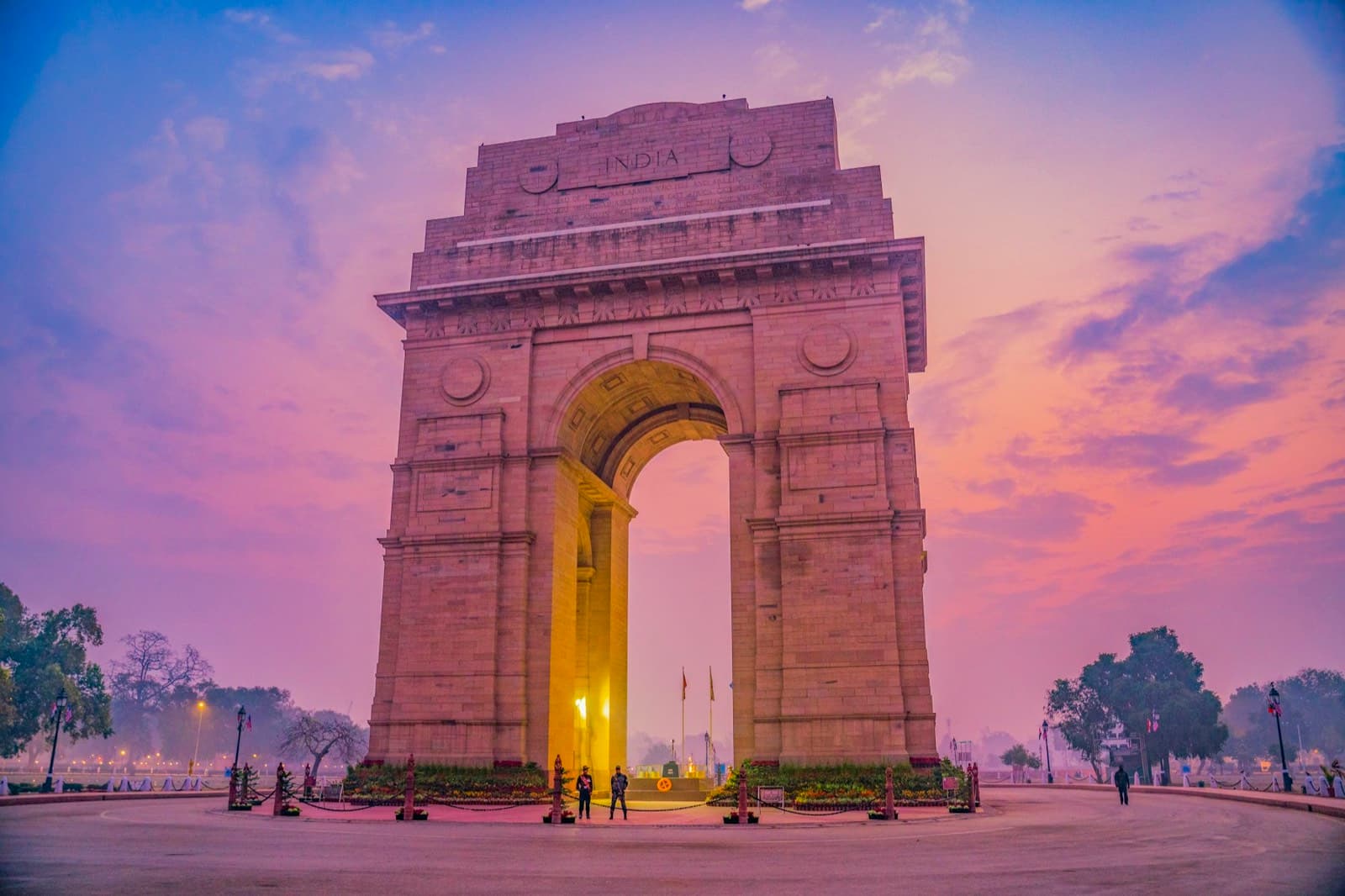 India Gate in New Delhi under a pink evening sky